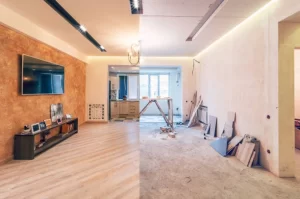 Room split between finished living space and ongoing renovation work in progress. -house renovation before and after