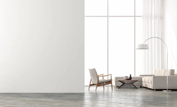Minimalist living room with concrete floor, large windows, and cozy furniture. -flooring contractors